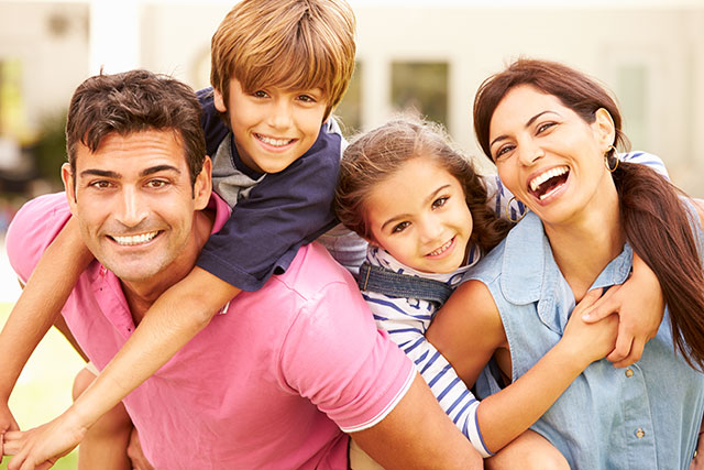 Happy family of four outdoors